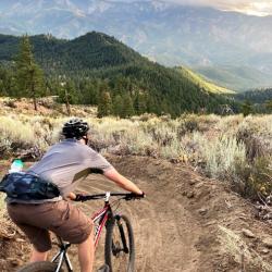 Mountain biker riding with views of the mountains
