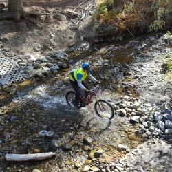 Mountain biker crossing stream